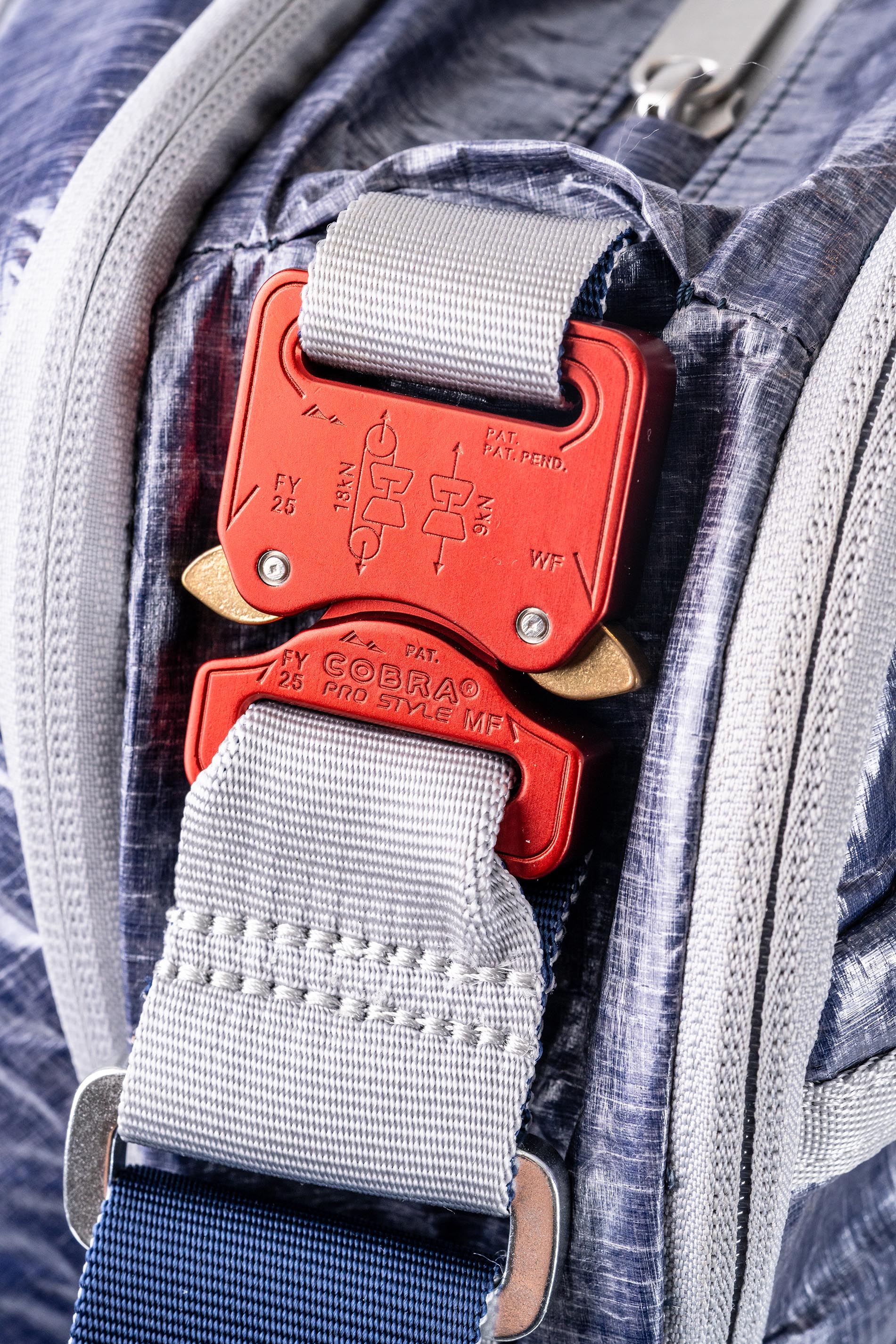 Close-up of a AustriAlpin Clip on a textured fabric background. 
