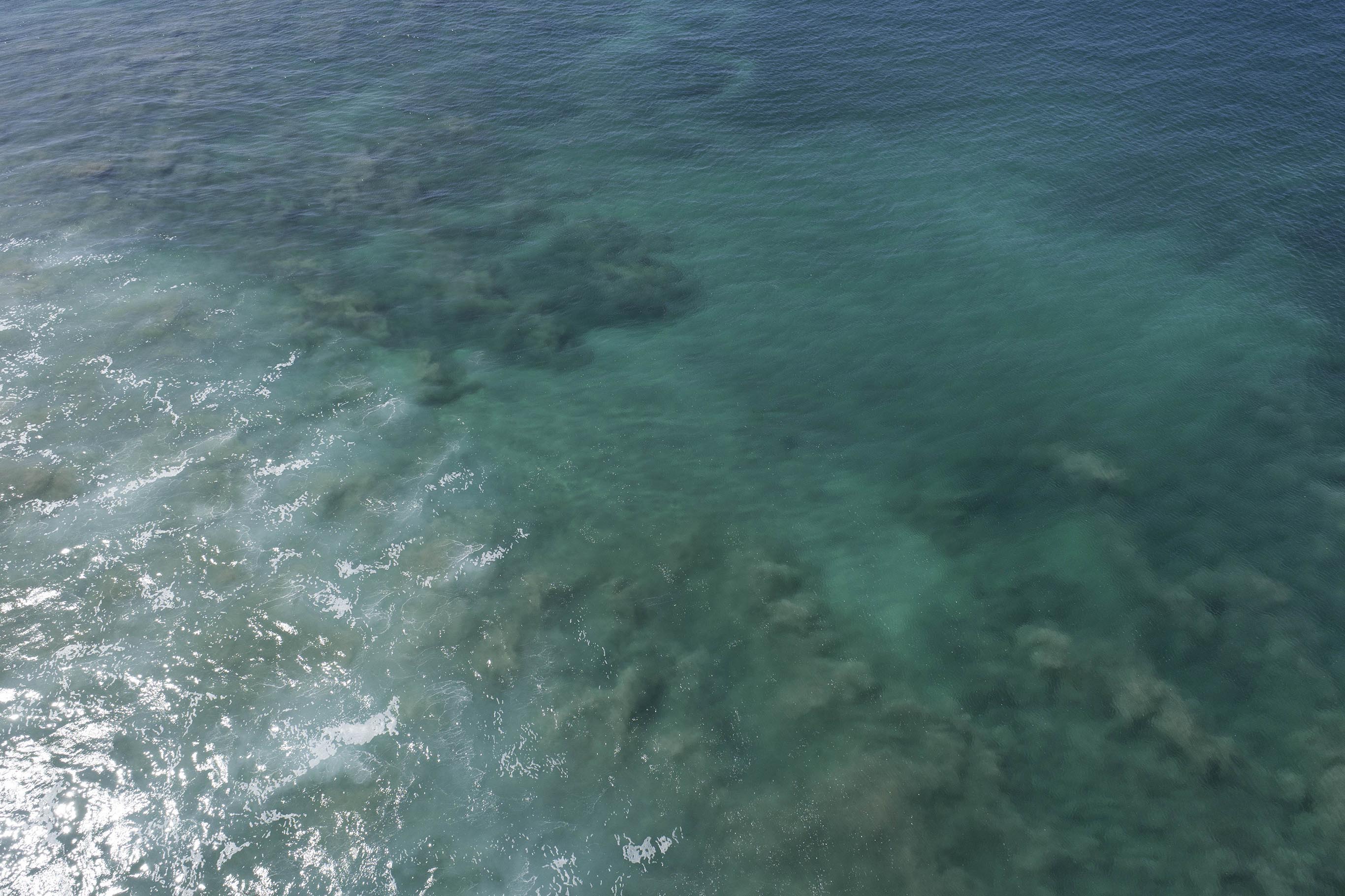 Clear blue water with underwater reef