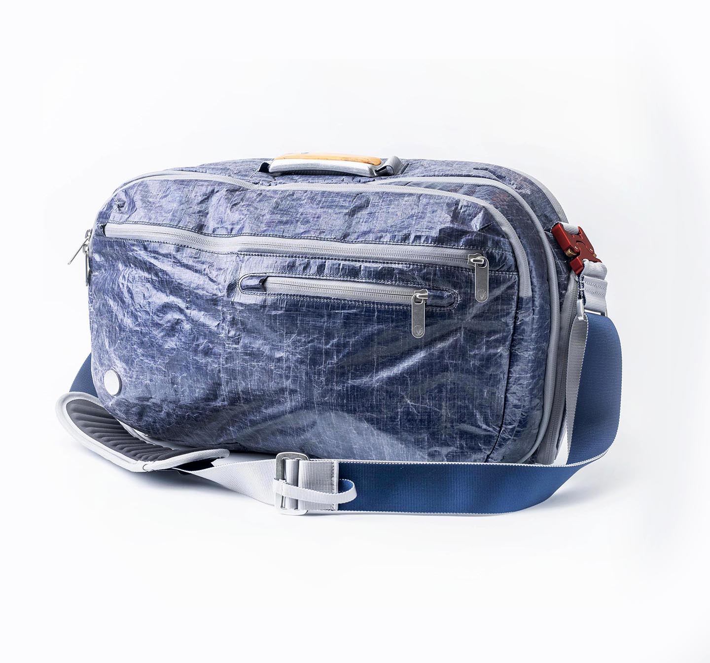 Side view of "White Cap" Work-to-Water Blue textured travel bag with multiple zippers, shown on a white background
