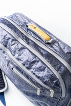 Blue "White Cap" Offsite Work to Water Bag, textured bag with a wood handle on a white background