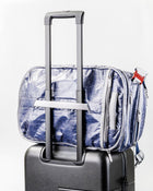 Textured Blue "White Cap" Work to Water bag with zippers attached to a suitcase on a white background