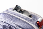 Sunglasses sticking out of pocket on the "White Cap"  Work to Water bag. 