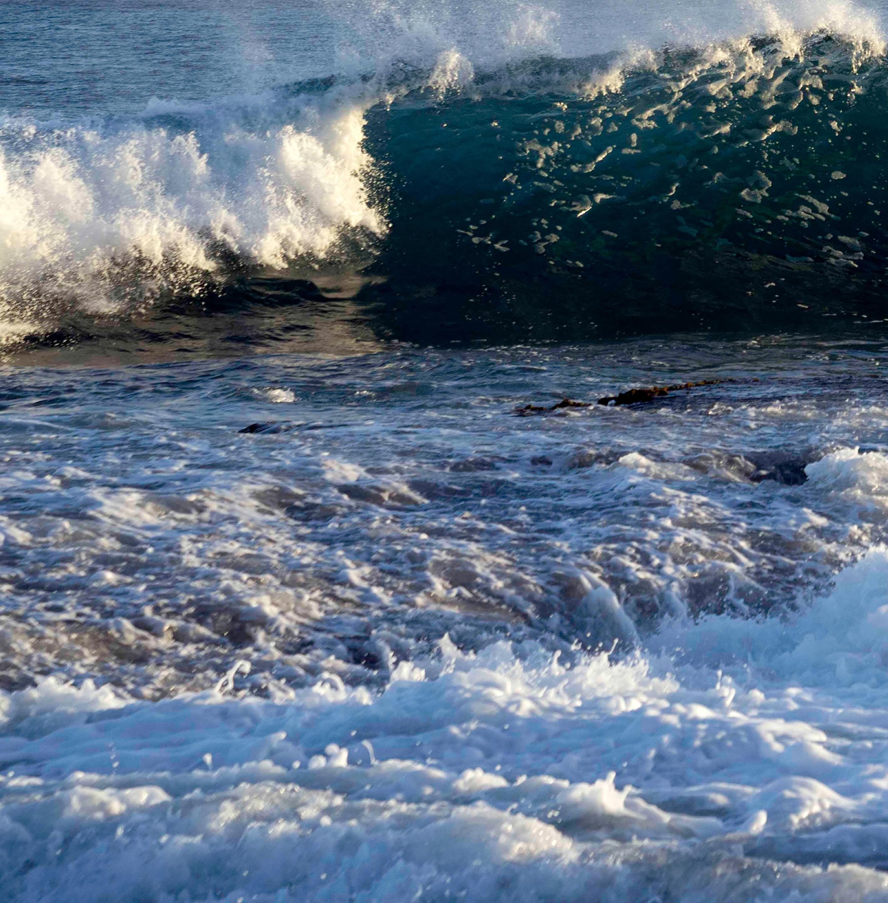Powerful dark blue waves crashing, with whitecap