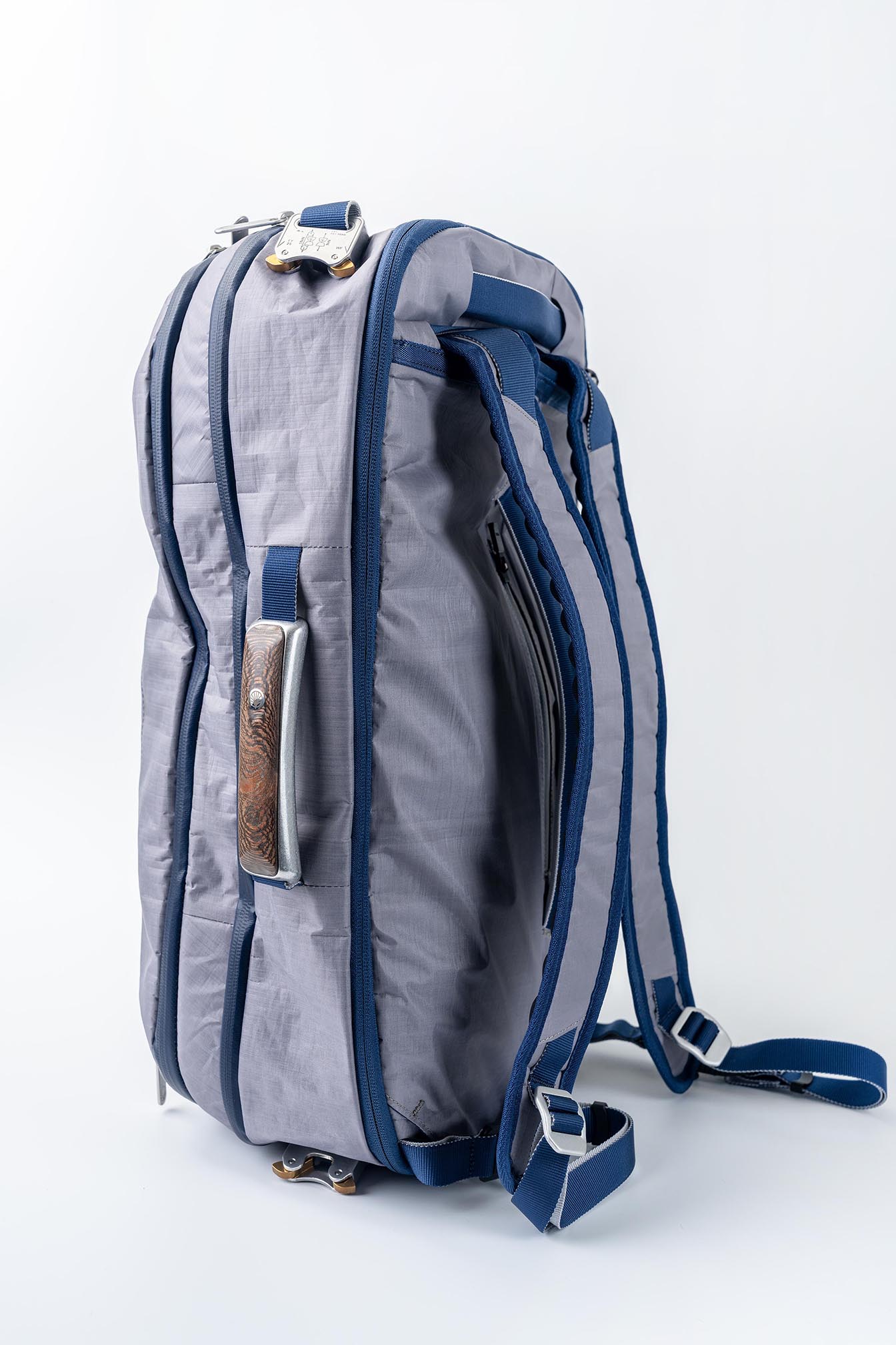 Offsite Work-to-Water Bag in Ocean blue Dyneema shown in backpack mode, featuring padded shoulder straps and signature wood-inlay aluminum handle
