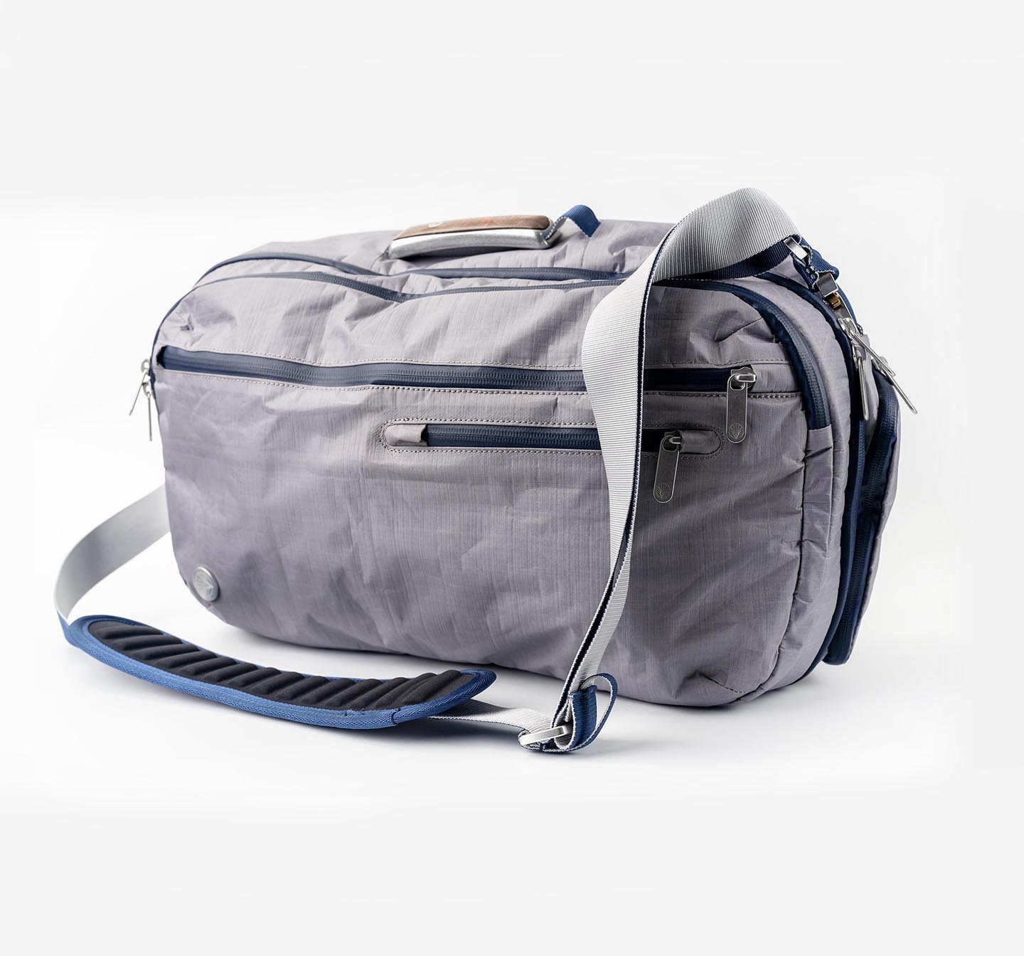 Offsite Work-to-Water Bag in Haze gray, shown in messenger carry with padded shoulder strap, custom wood-inlay handle, and logo coin