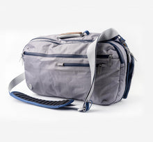 Offsite Work-to-Water Bag in Haze gray, shown in messenger carry with padded shoulder strap, custom wood-inlay handle, and logo coin