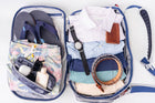 Top-down view of the Offsite Work-to-Water bag fully packed with folded clothing, flip-flops, toiletries, sunglasses, and accessories, demonstrating organized weekender and travel capacity