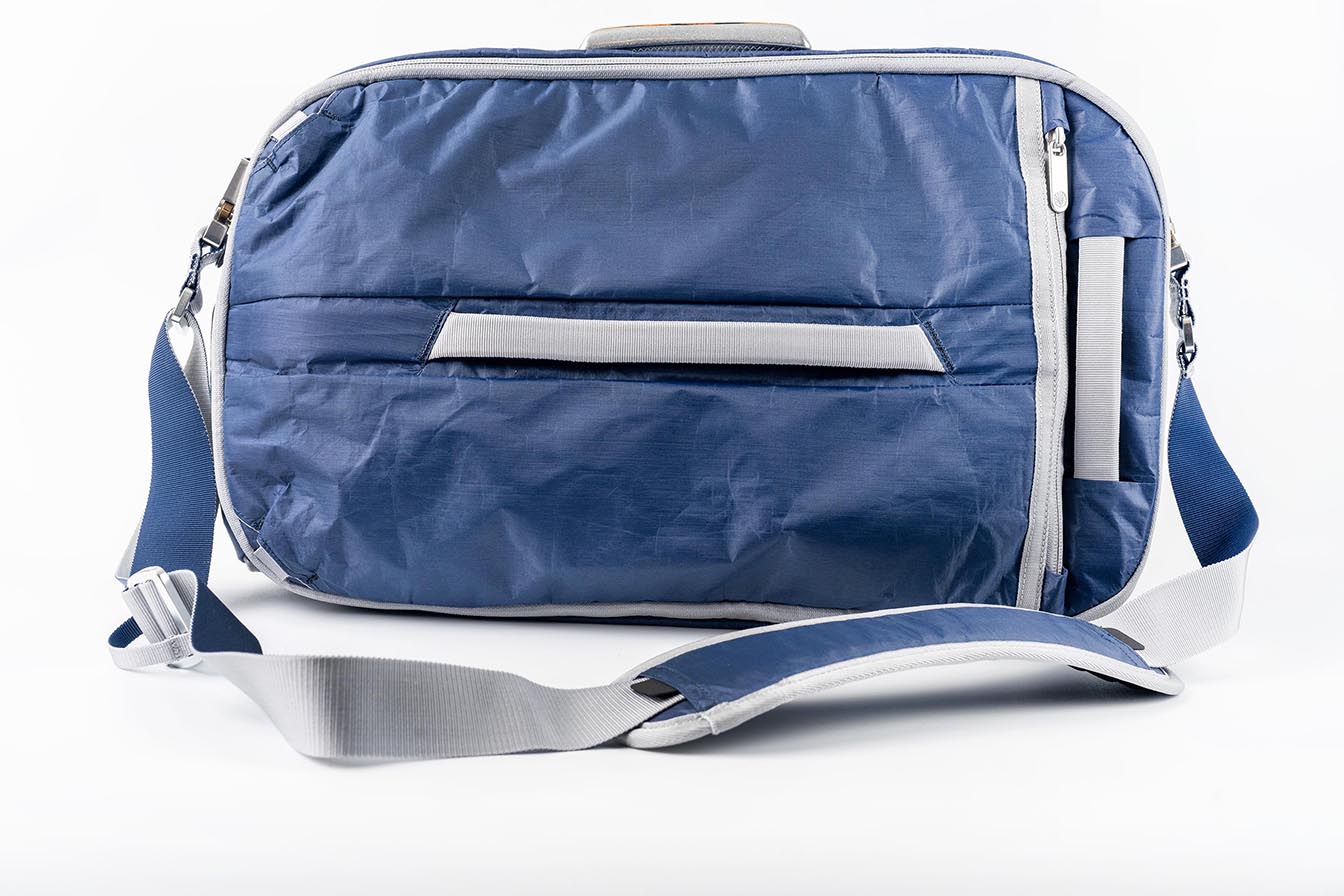 Rear view of the Offsite Work-to-Water Bag in Ocean blue, featuring Dyneema fabric, rear luggage pass-through, and adjustable padded shoulder strap