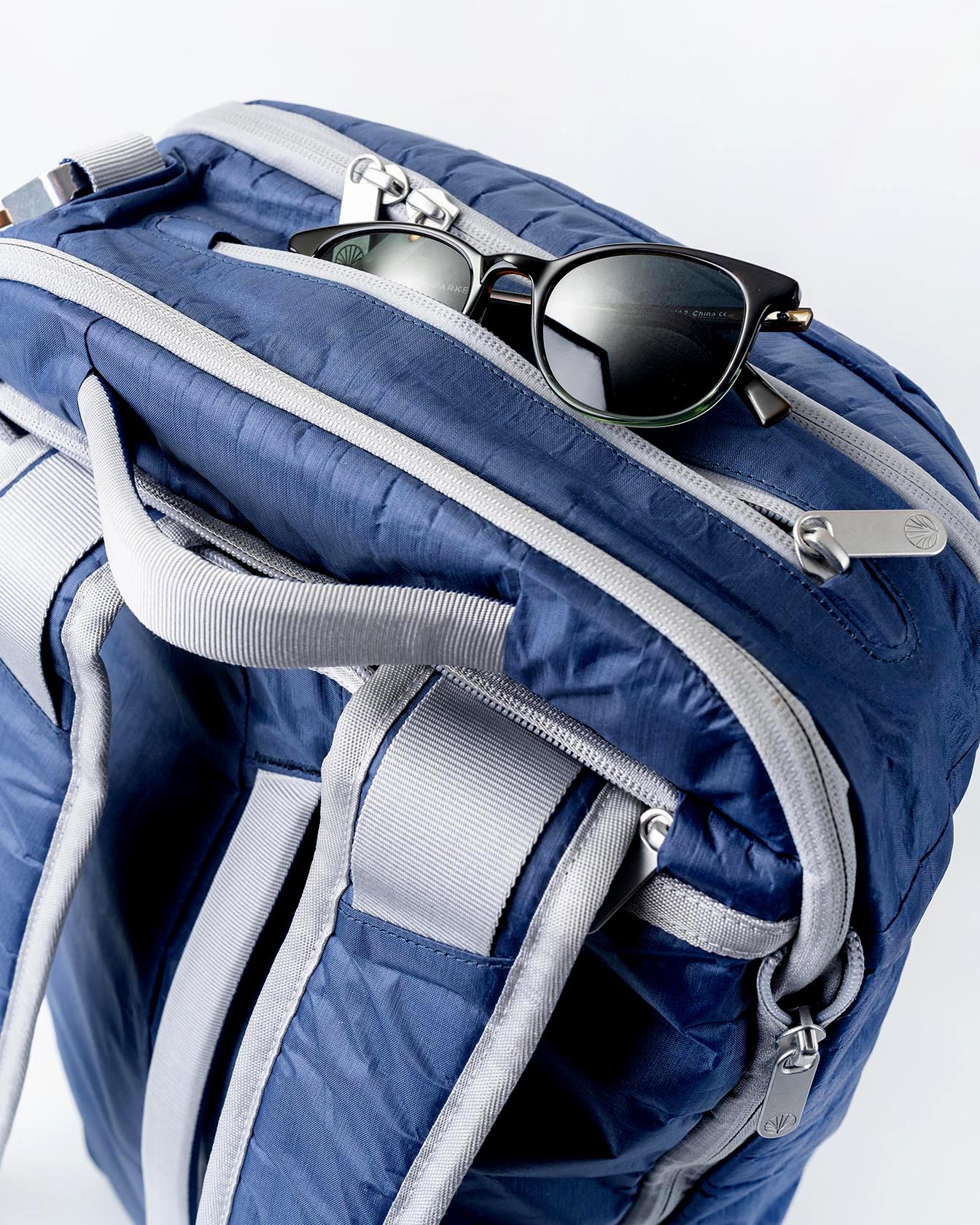 Offsite Work-to-Water Bag in Ocean blue Dyneema highlighting the Sunglasses Attic compression pocket for scratch-free sunglass storage