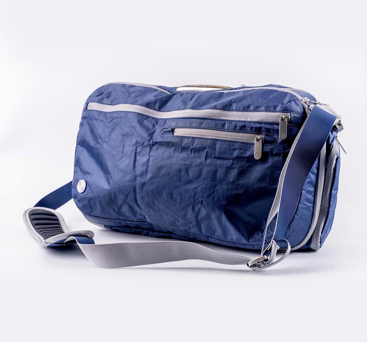 Front view of the Offsite Work-to-Water Bag in Ocean colorway, made from Dyneema fabric with adjustable shoulder strap.