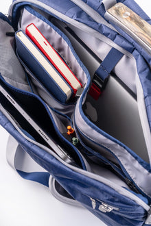 Interior view of the Offsite Work-to-Water Bag in Ocean blue showing padded laptop sleeve, tablet pocket, notebook storage, and organized interior compartments